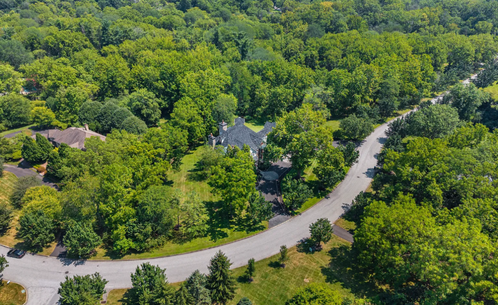 An aerial drone view of a winding suburban residential road in Wyndmoor, PA